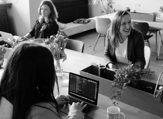 women on a large desk working together